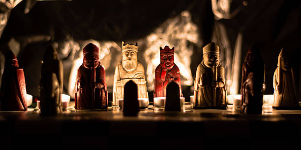 Replica of the Lewis Chessmen A shallow depth of field photograph lit by candlelight, of a replica of the Lewis chess set.  The original set is kept in the British Museum in London. british museum stock pictures, royalty-free photos & images