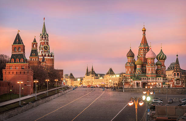 Pink minutes of Moscow evening Pink glow of sunset sky over Moscow Kremlin and St. Basil's Cathedral red square stock pictures, royalty-free photos & images