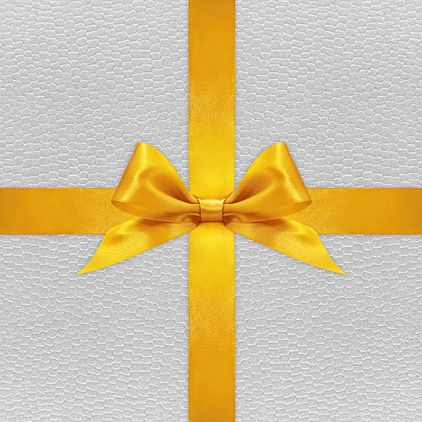 istock Shiny golden satin ribbon bow on silver background 500969904