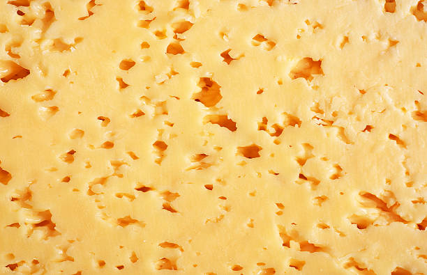 istock The texture of sour cheese slice close up. 500992884