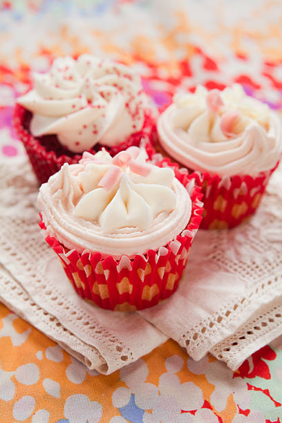 istock White chocolate fruit cupcakes in red paper 500993520