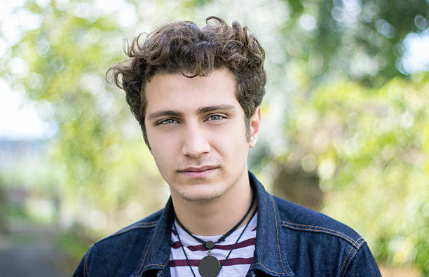 istock Portrait of young man against blurred trees 500994344