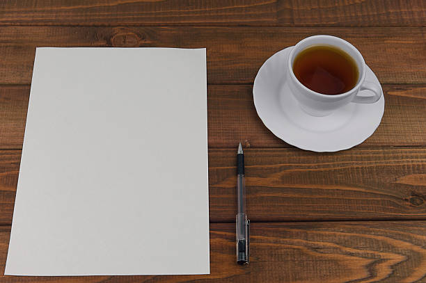istock White paper on a wooden table 500995886