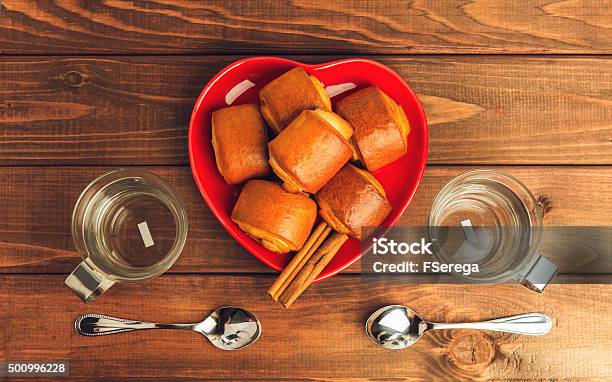 Two Empty Glass Cups With Metal Handles And Cinnamon Rolls Stock Photo - Download Image Now