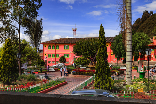 Nemocón, Colombia - September 19, 2015: The main town square in the town of Nemocón in the Cundinamarca Department of the Latin American country of Colombia. Some people can be seen on the square; flowering shrubs and trees decorate the square. Photo shot in the early afternoon sunlight; horizontal format.