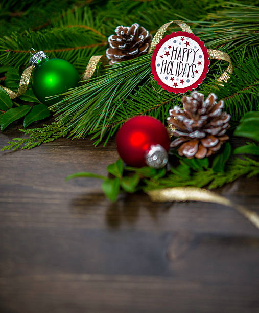 istock Rustic Christmas evergreen background with baubles and holiday message 500997190