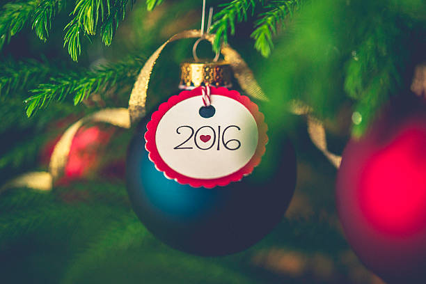 istock Christmas bauble with New Year message on Christmas tree branches 500997250