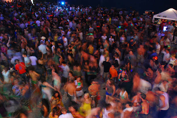 A crowd of people from around the world dance at the monthly Full Moon Party on Haad Rin, a beach on Ko Phangan, Thailand