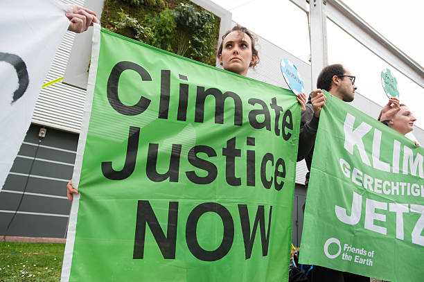 COP21 climate conference protest Paris, France - December 1, 2015: Climate activists at the COP21 UN climate summit in Paris, France, stage a protest calling for "climate justice now", December 1, 2015. climate justice stock pictures, royalty-free photos & images