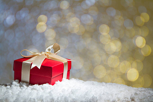 istock Red gift box on snow with abstact bokeh background. 501001994