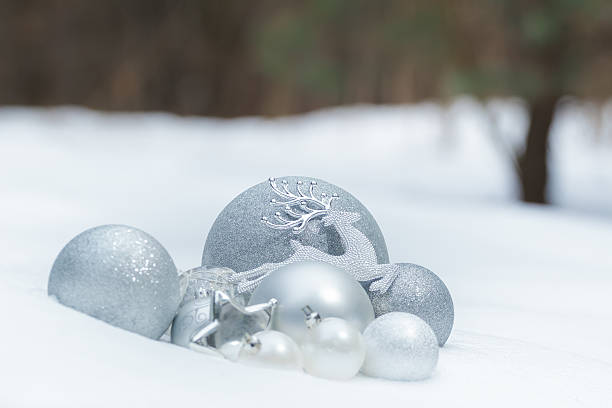 istock Silver grey shiny Christmas ornaments with reindeer on snowy ground 501003166