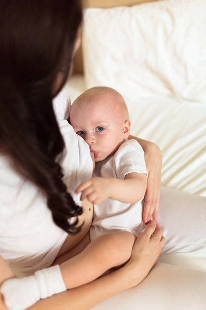 istock Baby with her mother , light,   breastfeeding 501004326
