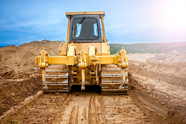 istock Bulldozer with steel blade moving soil and sand around 501026875