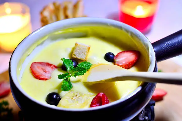 Photo of cheese fondue with fruit