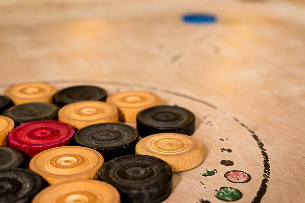 istock Carrom men pieces arranged on a board 501028950