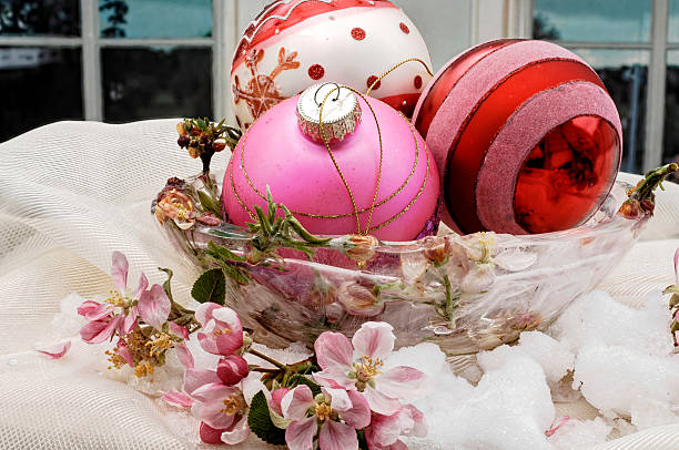 istock colored Christmas baubles in an ice bowl with blossoms 501029280