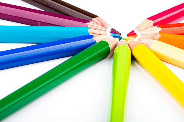 different colored pencils on white background stock photo