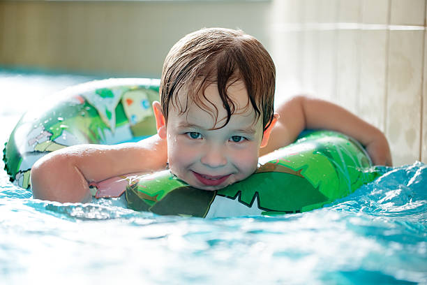 istock Young boy in inflatable tube swimming 501030797