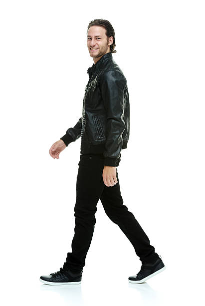 istock Side view of happy young man walking 501030909