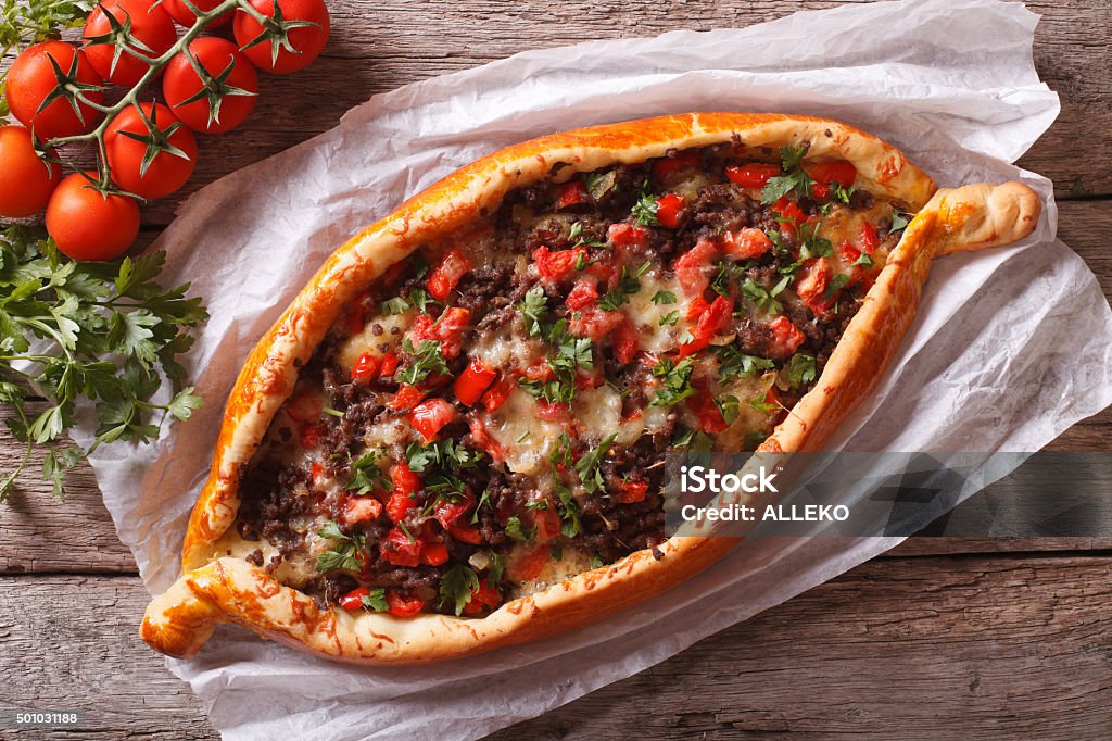Turkish pide pizza with meat closeup. horizontal view from above Turkish pide pizza with meat and vegetables close-up on the table. horizontal view from above Pizza Stock Photo