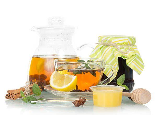 istock pot of tea with lemon, honey and jam on white 501033130