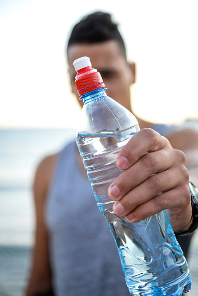 istock Young muscular man holding a bottle. 501033326