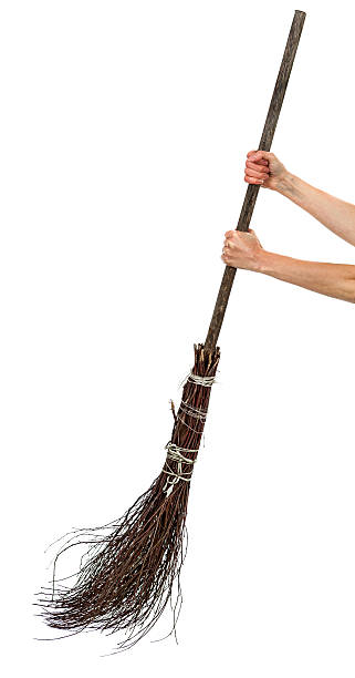 Two hands holding wicked broom stock photo