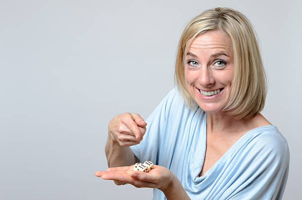 istock Gleeful woman pointing to triple six dice 501037918