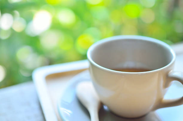 istock Blur a cup of coffee on wood table abstract background. 501038194