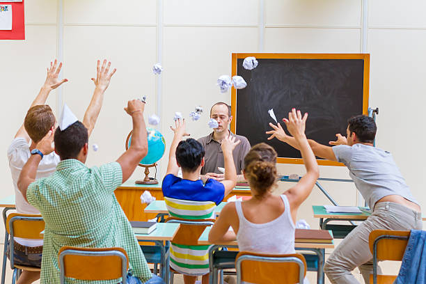 istock Students throwing paper balls to Teacher 501041531