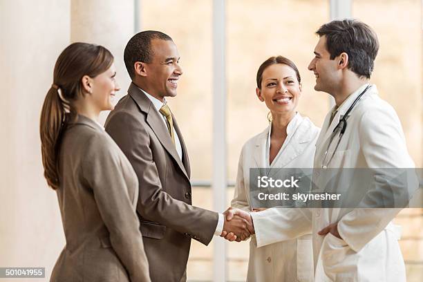 Businessman Shaking Hands With A Doctor Stock Photo - Download Image Now - Doctor, Handshake, Businessman