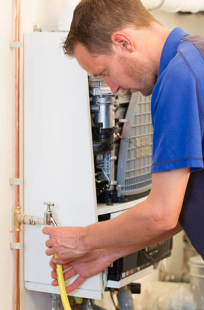 istock Plumber repairing a heater in house 501042917