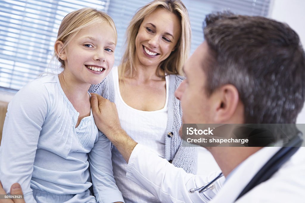 Getting a clean bill of health Shot of a little girl's visit to the doctor with her mother Adult Stock Photo