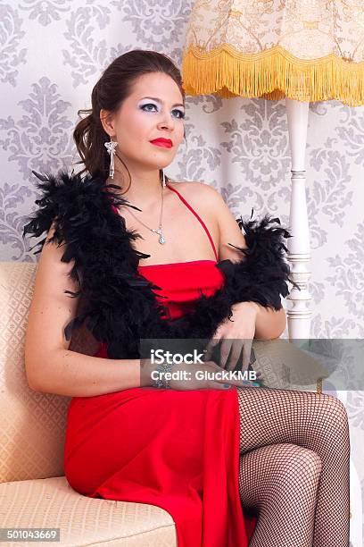 Girl Sitting On Sofa In Retro Interior Stock Photo - Download Image Now - Adult, Adults Only, Arts Culture and Entertainment