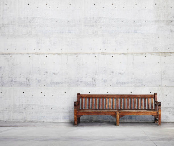 istock Old wood bench on bright concrete background 501044035