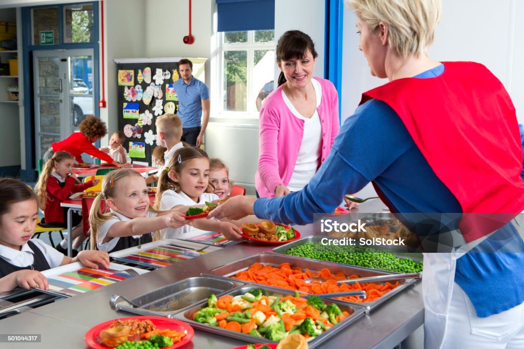 School Caferteria Line Dinner is served out to children as they line up at a school canteen Education Stock Photo