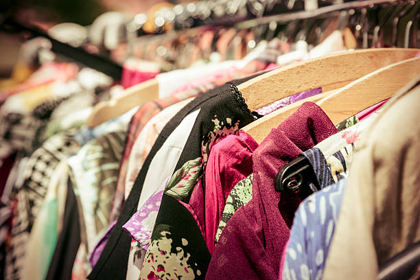 istock clothes on a rack on a flea market 501045361
