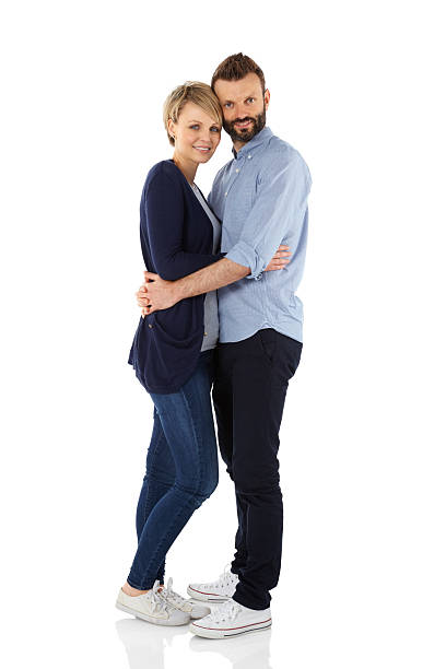 istock Loving young couple embracing over white 501045913