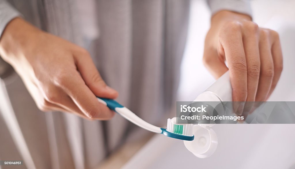 Forcing her way to a bright smile Portrait of an attractive young woman brushing her teethhttp://195.154.178.81/DATA/i_collage/pi/shoots/783515.jpg Toothpaste Stock Photo