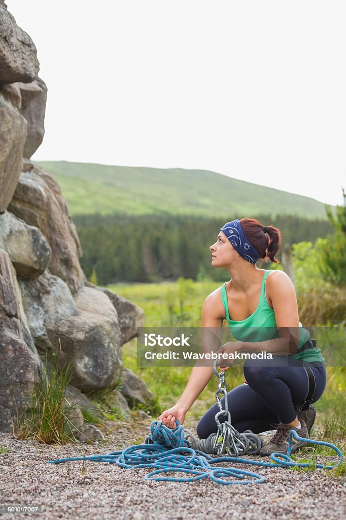 Pretty rock climber looking up at her challenge Pretty rock climber looking up at her challenge in the countryside 20-29 Years Stock Photo