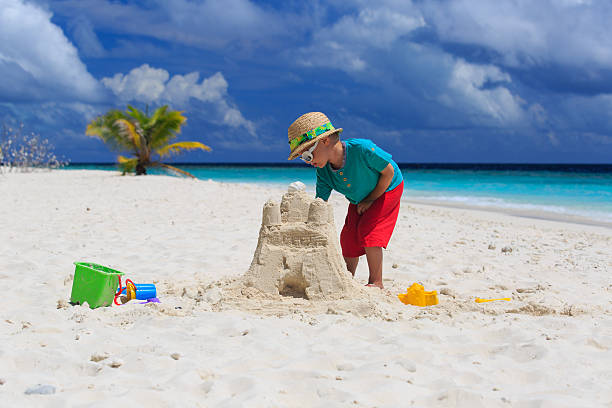 istock child building sand castle on tropical beach 501047041