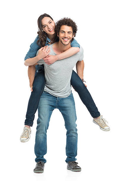 Man Giving Piggyback Ride To Her Girlfriend Portrait Of Young Man Piggybacking Her Girlfriend Isolated On White Background on shoulders stock pictures, royalty-free photos & images