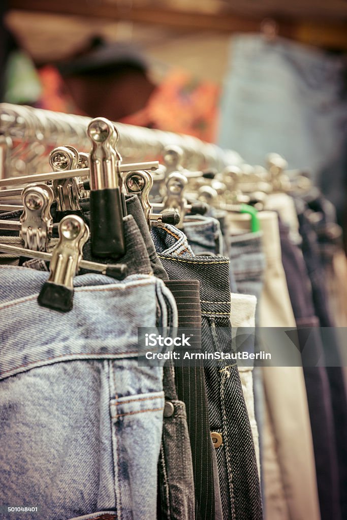 clothes on a rack on a flea market clothes on a rack on a flea market. Abundance Stock Photo