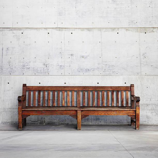 istock Old wood bench on bright concrete background 501048417