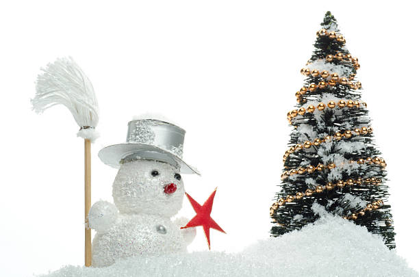 istock snowman with broom in snow with christmas tree 501057104
