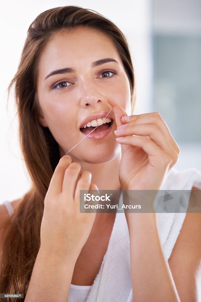 For the brightest smile ever Portrait of an attractive young woman holding dental floss and smilinghttp://195.154.178.81/DATA/i_collage/pi/shoots/783538.jpg 20-24 Years Stock Photo