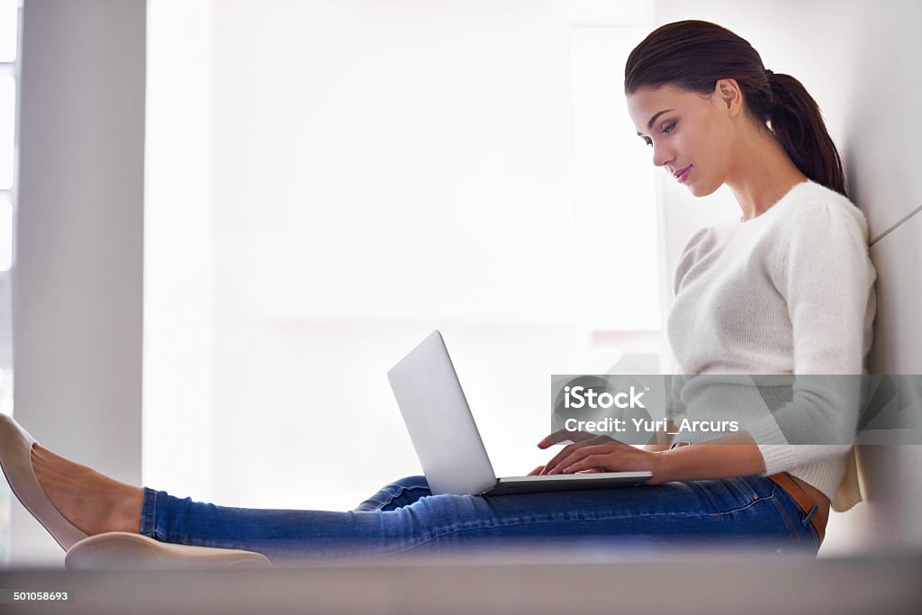 Just 5 more minutes online A beautiful young woman sitting on her floor  and using a laptophttp://195.154.178.81/DATA/i_collage/pi/shoots/783588.jpg Profile View Stock Photo