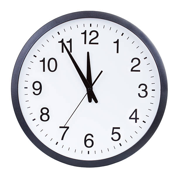 istock Clock face showing the hands at five minutes to midnight 501058795