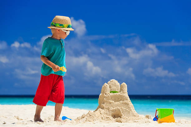 istock child building sand castle on tropical beach 501059513