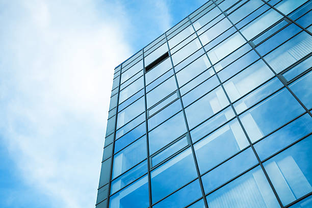 istock Modern office building wall made of glass with sky 501060129